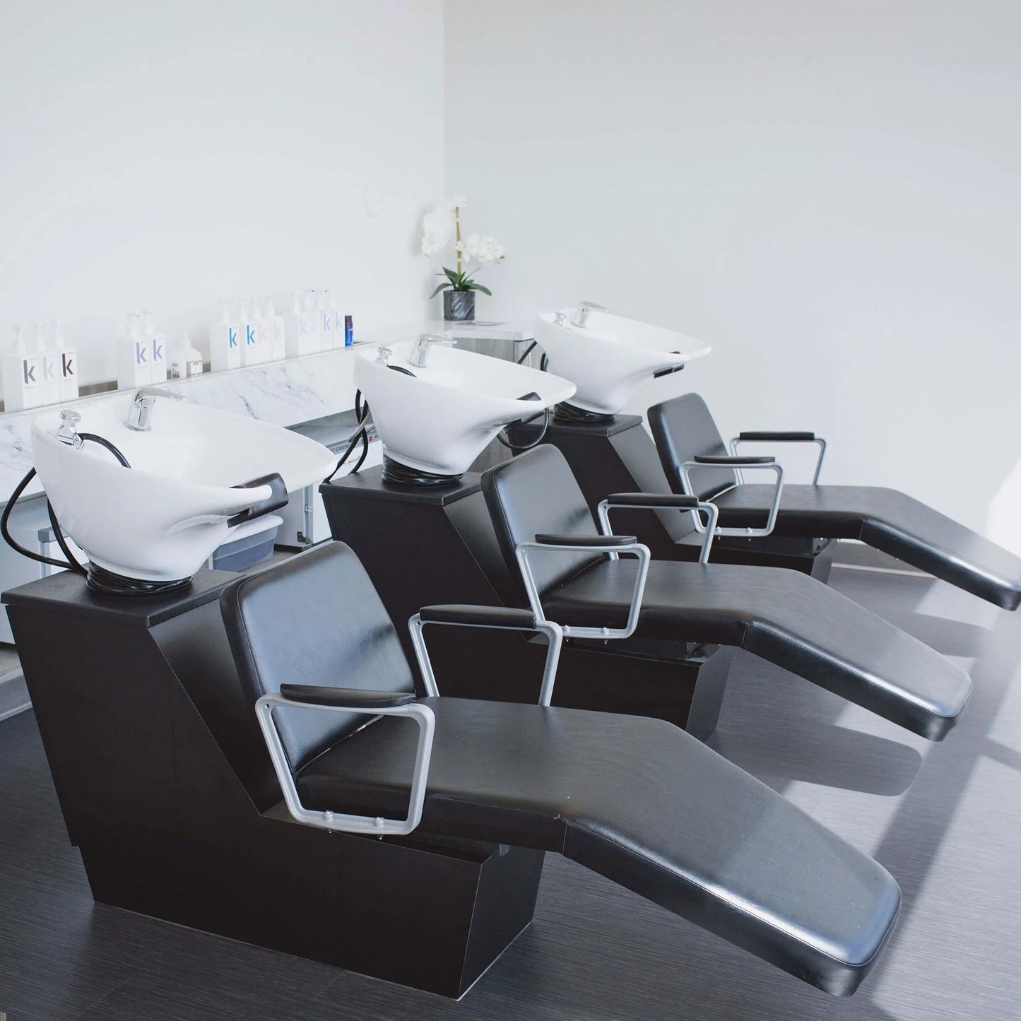 Collins Leslie lounge shuttle designed for salon shampoo lounges, featuring a sturdy base and clean, modern styling for backwash integration.