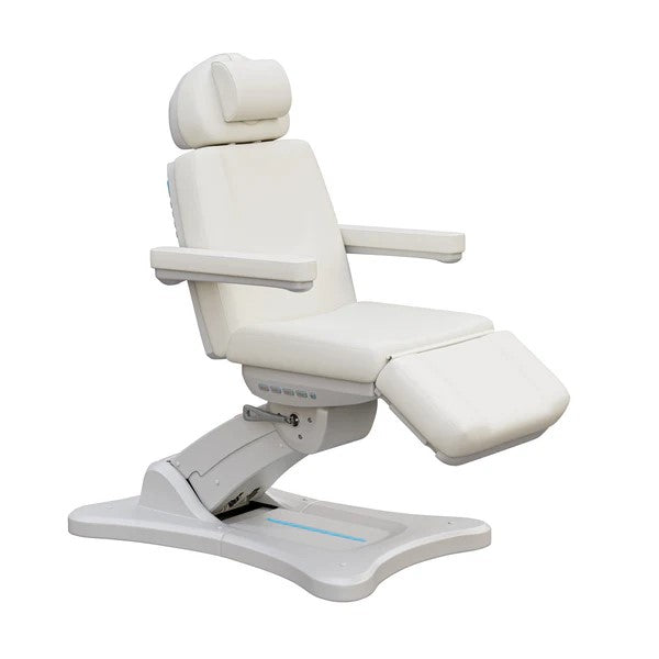 White adjustable medical treatment chair with headrest, armrests, and leg support on a hydraulic base.