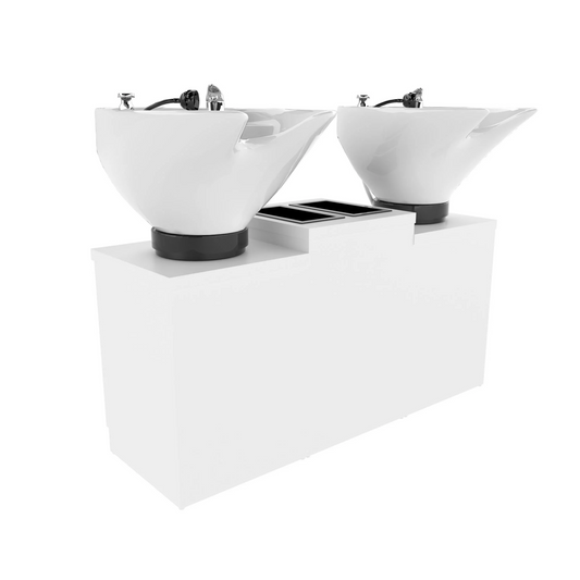 Two white porcelain tilting bowls mounted on Collins twin shampoo pedestals with a bottle well storage cabinet in a salon setting.