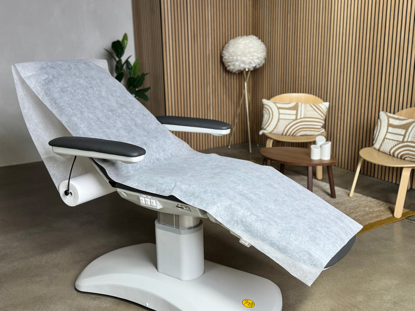 disposable bed sheet roll in medical clinic treatment room hygiene setup