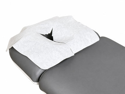 disposable face cradle cover on massage table headrest spa treatment setup