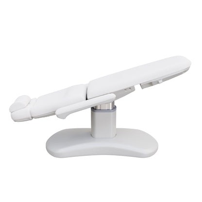 Spa Numa LUCENT 4 motor luxury electric treatment chair in vegan leather with pedestal base, reversible armrests, extendable headrest, and Trendelenburg position—ideal for high-end spa, salon, and aesthetic treatment procedures in compact spaces.