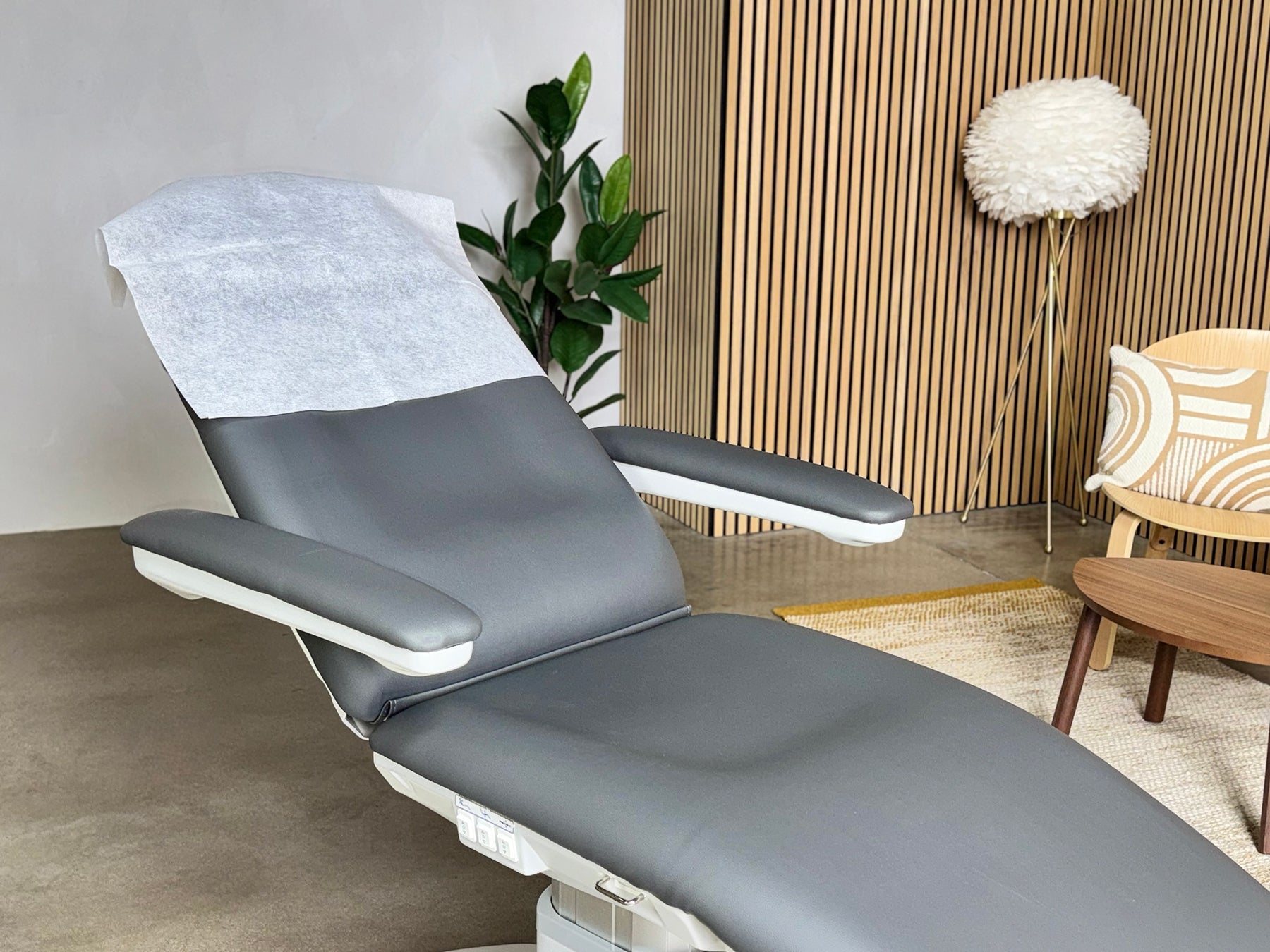disposable pillow cover on facial bed headrest spa treatment setup