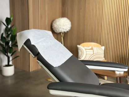 spa treatment room setup with disposable pillow covers hygiene setup