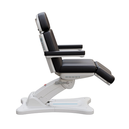 Spa Numa SERENITY 4 motor electric treatment chair in medical black vegan leather with 240-degree rotation, ADA-compliant 20-inch seat height, adjustable headrest, removable armrests, and LED-lit controls—ideal for aesthetic procedures, post-op evaluations, and outpatient treatments.