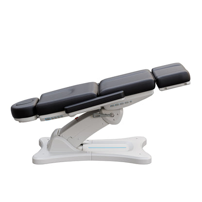 Spa Numa SERENITY 4 motor electric treatment chair in medical black vegan leather with 240-degree rotation, ADA-compliant 20-inch seat height, adjustable headrest, removable armrests, and LED-lit controls—ideal for aesthetic procedures, post-op evaluations, and outpatient treatments.
