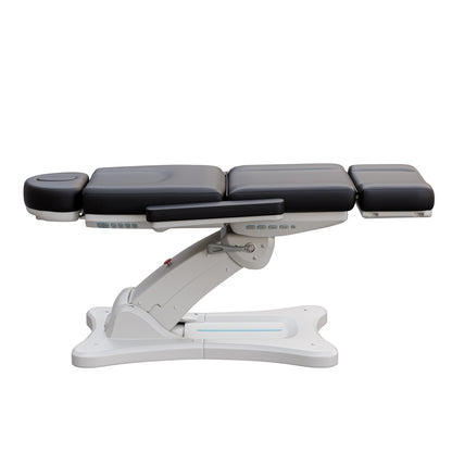 Spa Numa SERENITY 4 motor electric treatment chair in medical black vegan leather with 240-degree rotation, ADA-compliant 20-inch seat height, adjustable headrest, removable armrests, and LED-lit controls—ideal for aesthetic procedures, post-op evaluations, and outpatient treatments.