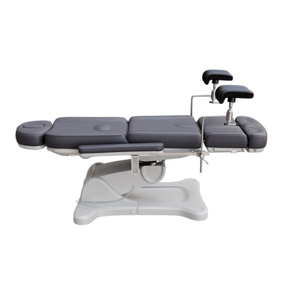 Spa Numa fully electric OB-GYN treatment chair with 240° swivel, surgical-grade stainless steel stirrups, adjustable backrest and leg rest, removable armrests, and PU leather upholstery for medical and esthetic use.