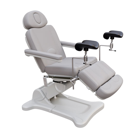 Fully electric Spa Numa OB-GYN swivel treatment chair with removable stainless-steel stirrups, extendable headrest, 240-degree rotation, and PU vinyl upholstery.