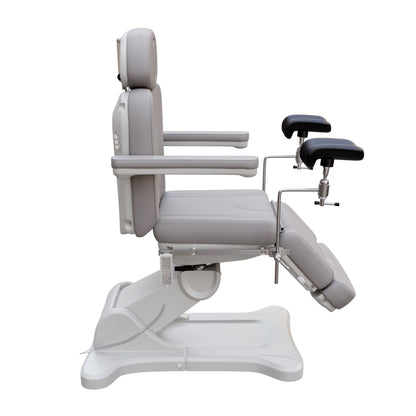 Fully electric Spa Numa OB-GYN swivel treatment chair with removable stainless-steel stirrups, extendable headrest, 240-degree rotation, and PU vinyl upholstery.