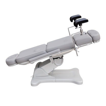 Fully electric Spa Numa OB-GYN swivel treatment chair with removable stainless-steel stirrups, extendable headrest, 240-degree rotation, and PU vinyl upholstery.
