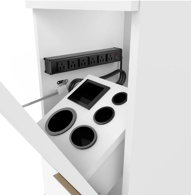 A white countertop beverage station with four circular black drink holders, a central black rectangular panel, a black power strip mounted on the back wall, and coiled black cords, shown in a clean white interior setting.