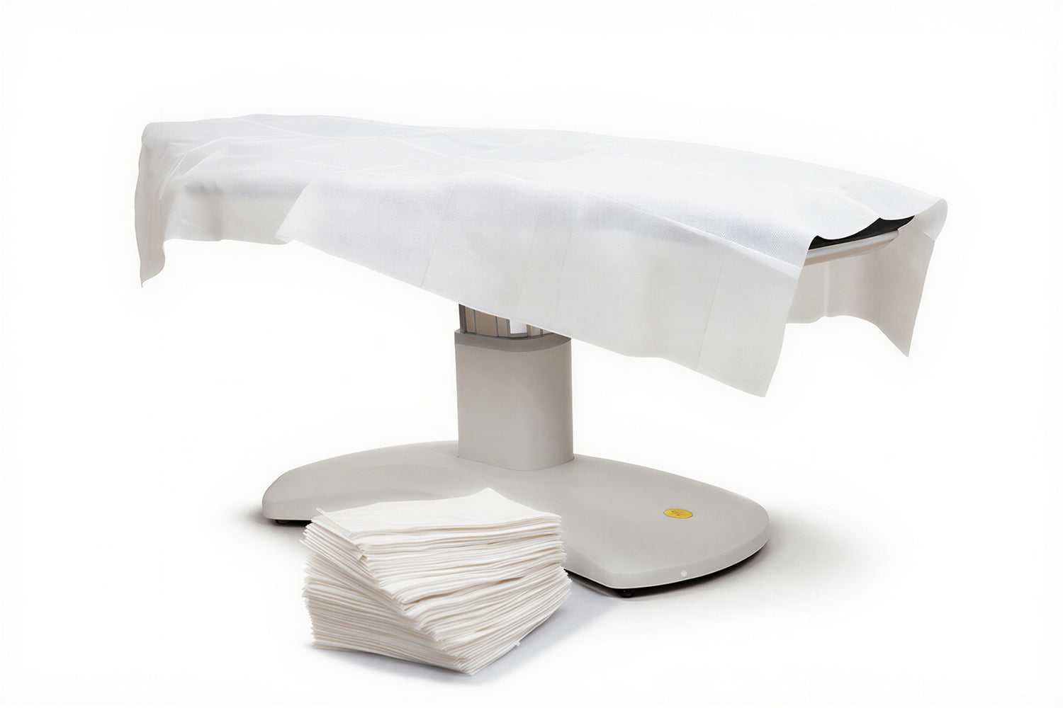 disposable flat bed sheet on spa treatment chair clean professional setup