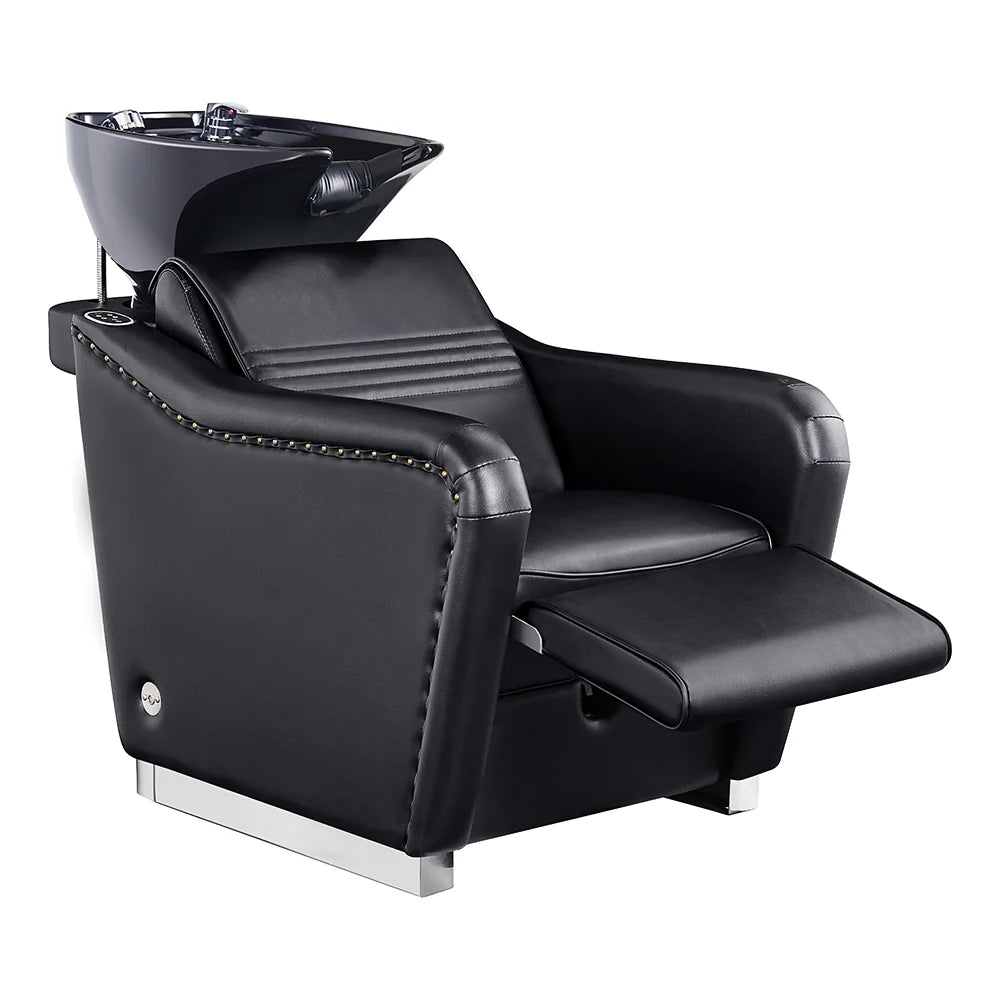 Black salon chair with built-in shampoo bowl on a white background