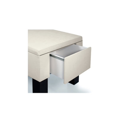 Monolith massage table with sleek architectural base and soft upholstery