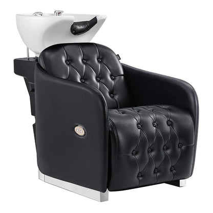 Black tufted salon chair with white basin on a white background