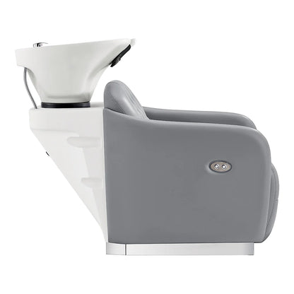 Gray salon chair with white basin and faucet on a white background